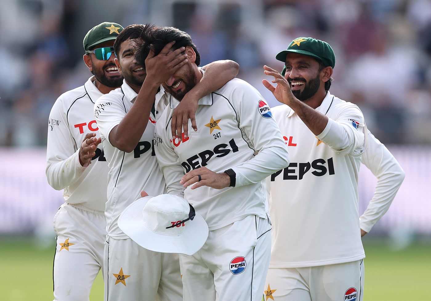 Salman Agha is mobbed by his team-mates after taking a brilliant catch