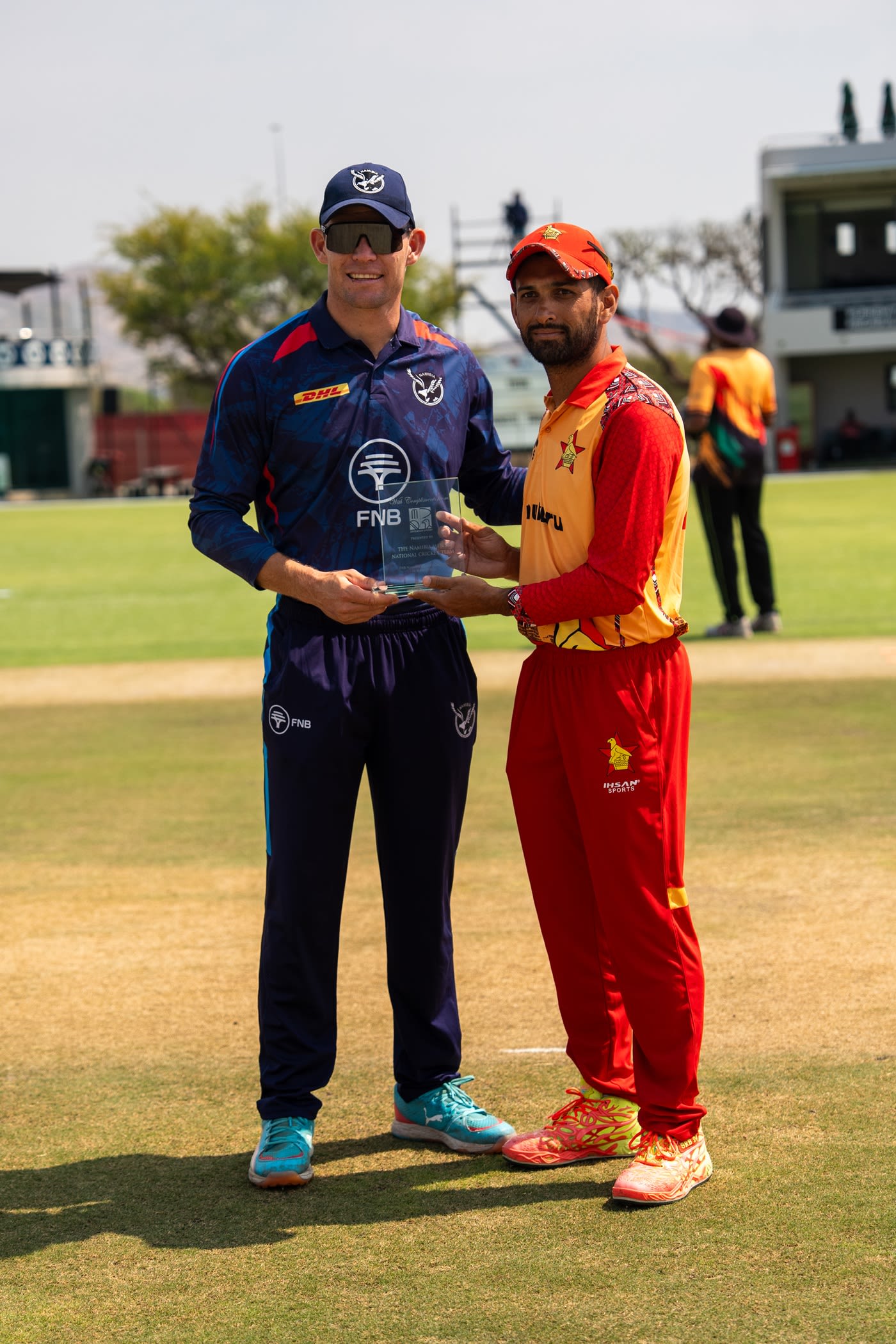 Gerhard Erasmus of Namibia and Sikandar Raza of Zimbabwe at the toss