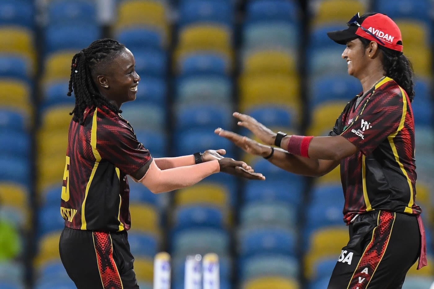Deandra Dottin and Shikha Pandey celebrate a wicket