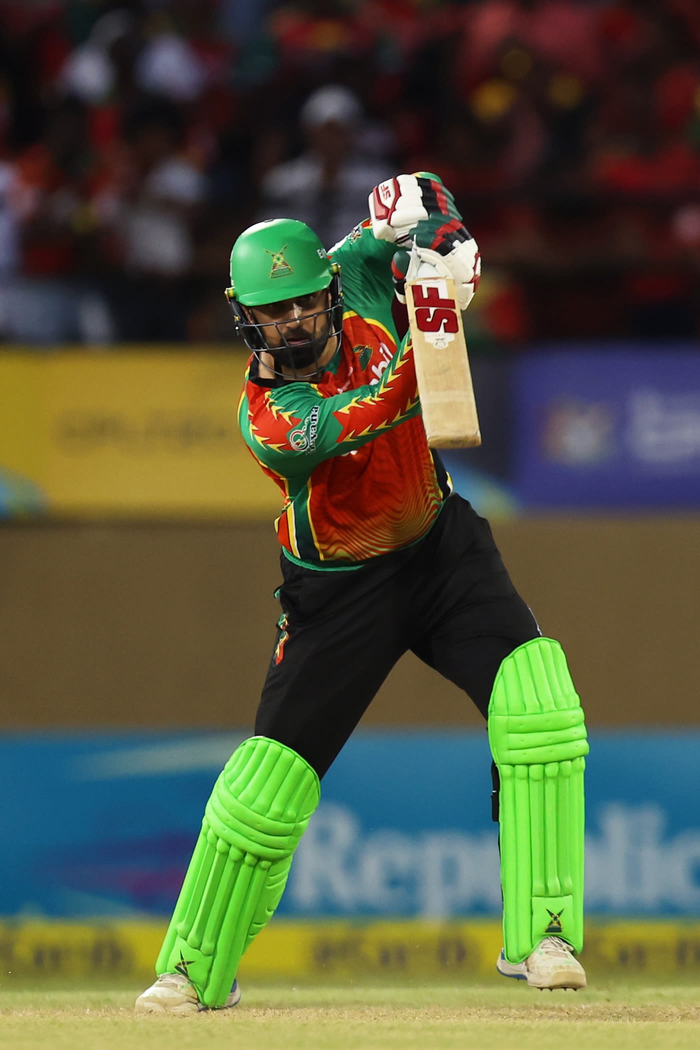 Mohammad Nabi punches the ball towards the covers