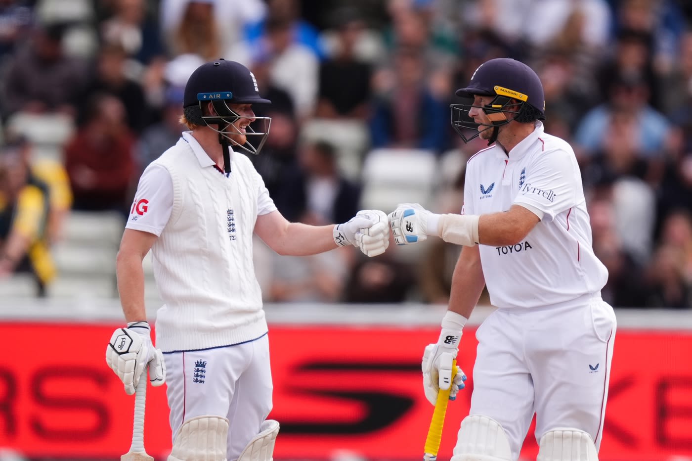 Jordan Cox gets a fist bump from Joe Root on reaching fifty