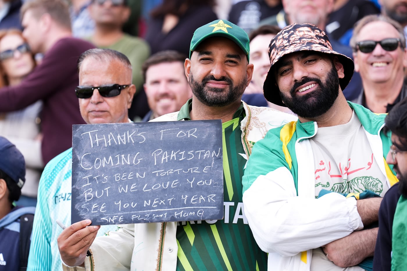 Pakistan fans hold up a message for their team