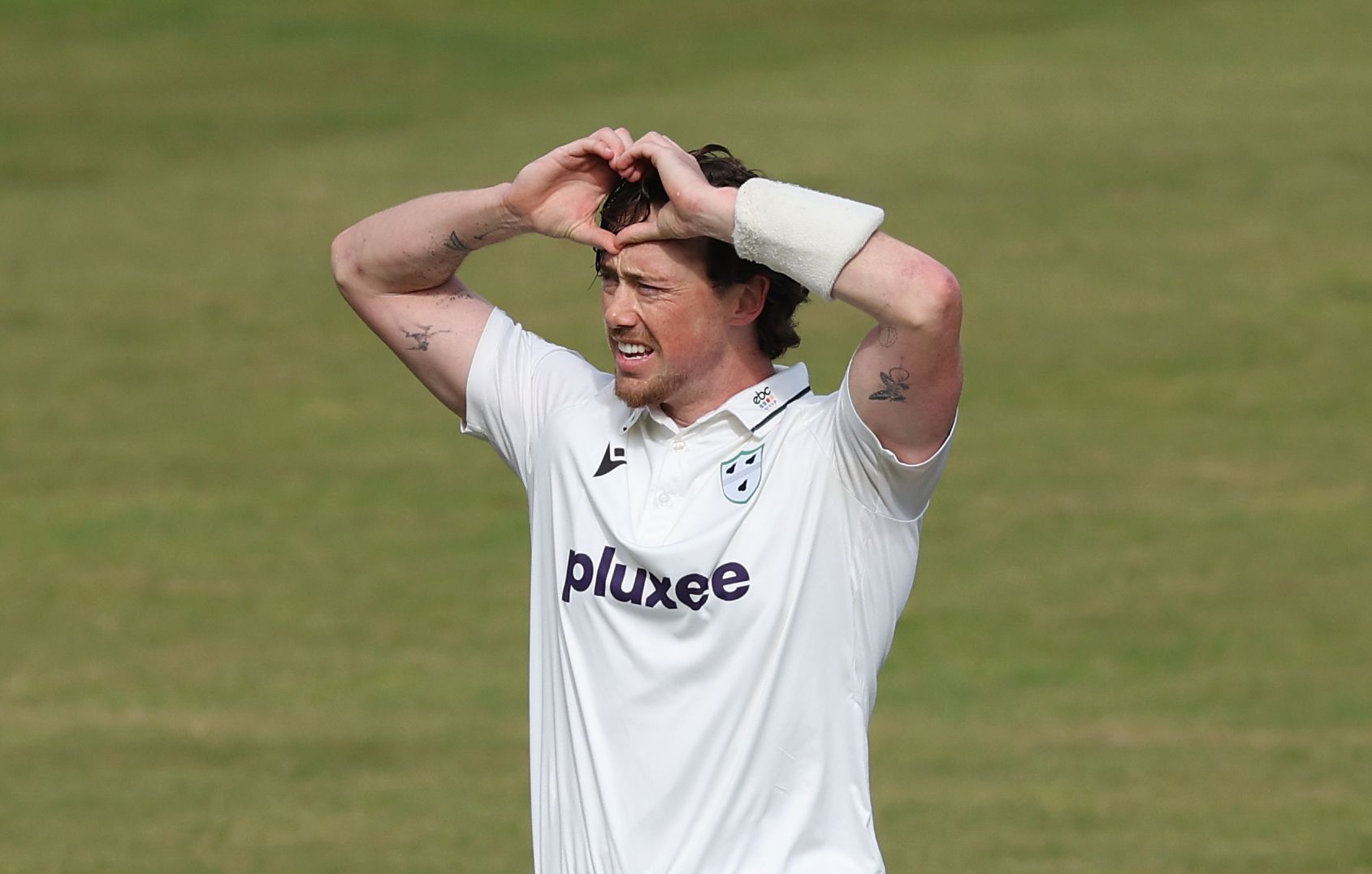 Adam Hose celebrates reaching his century