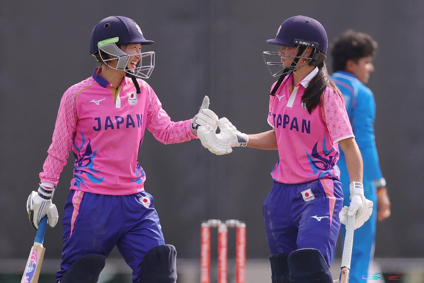 Haruna Iwasaki and Ayaka Kato-Stafford bump gloves during their opening stand