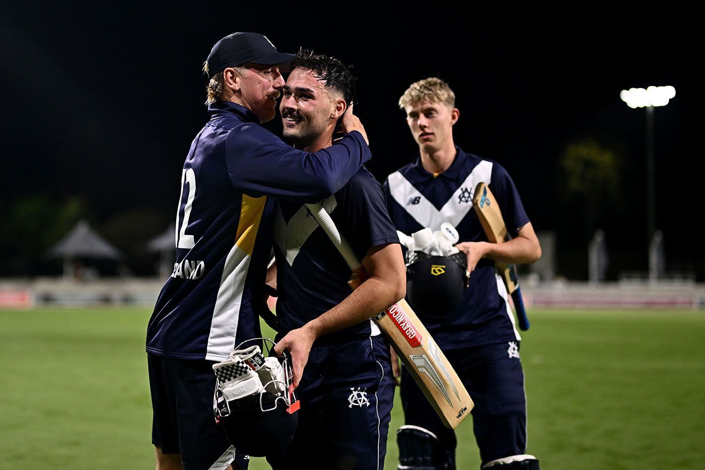 Liam Blackford (centre) is congratulated by Victoria captain Will Sutherland