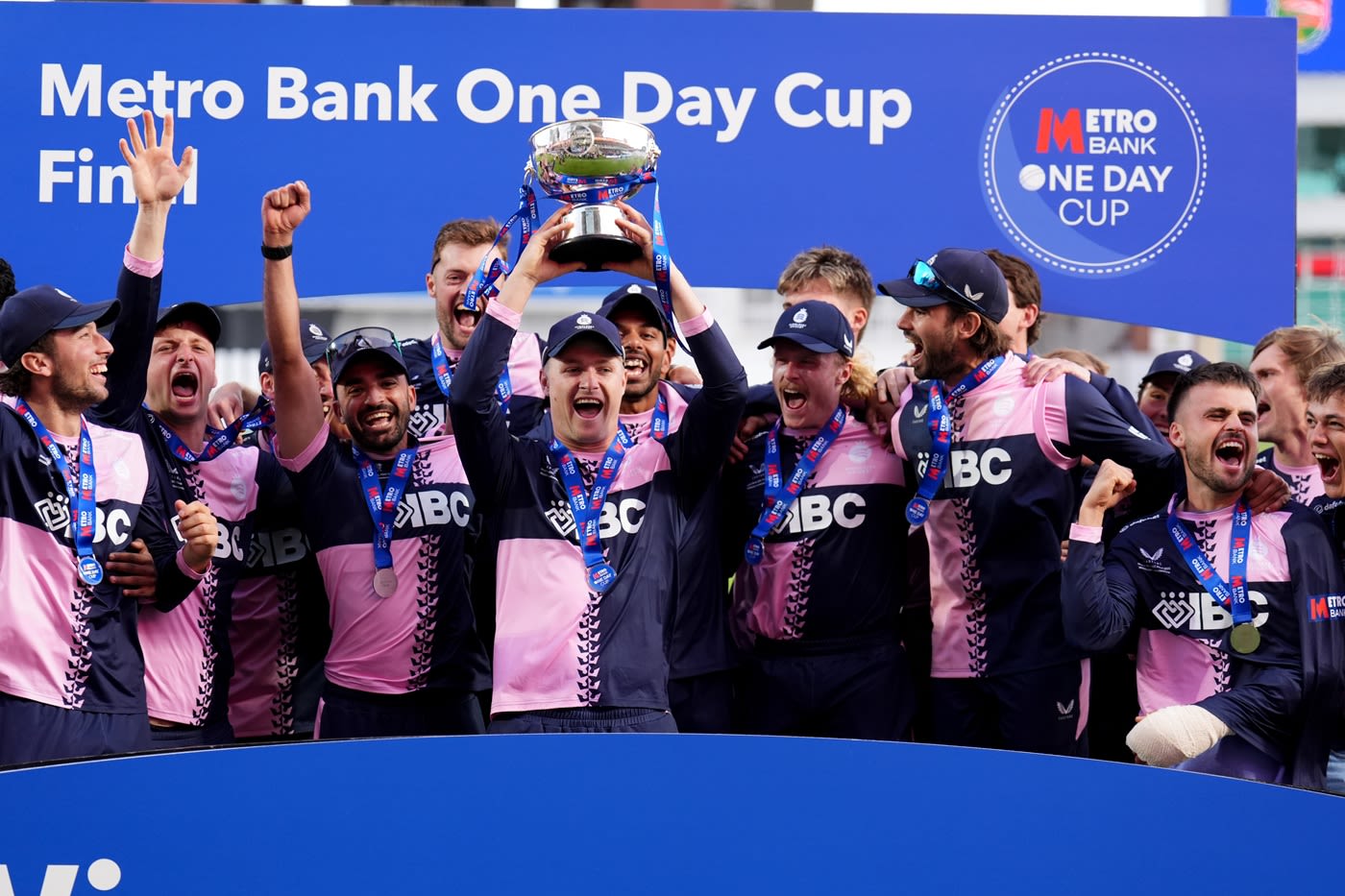 Ben Geddes holds the Metro Bank Cup aloft with his team-mates