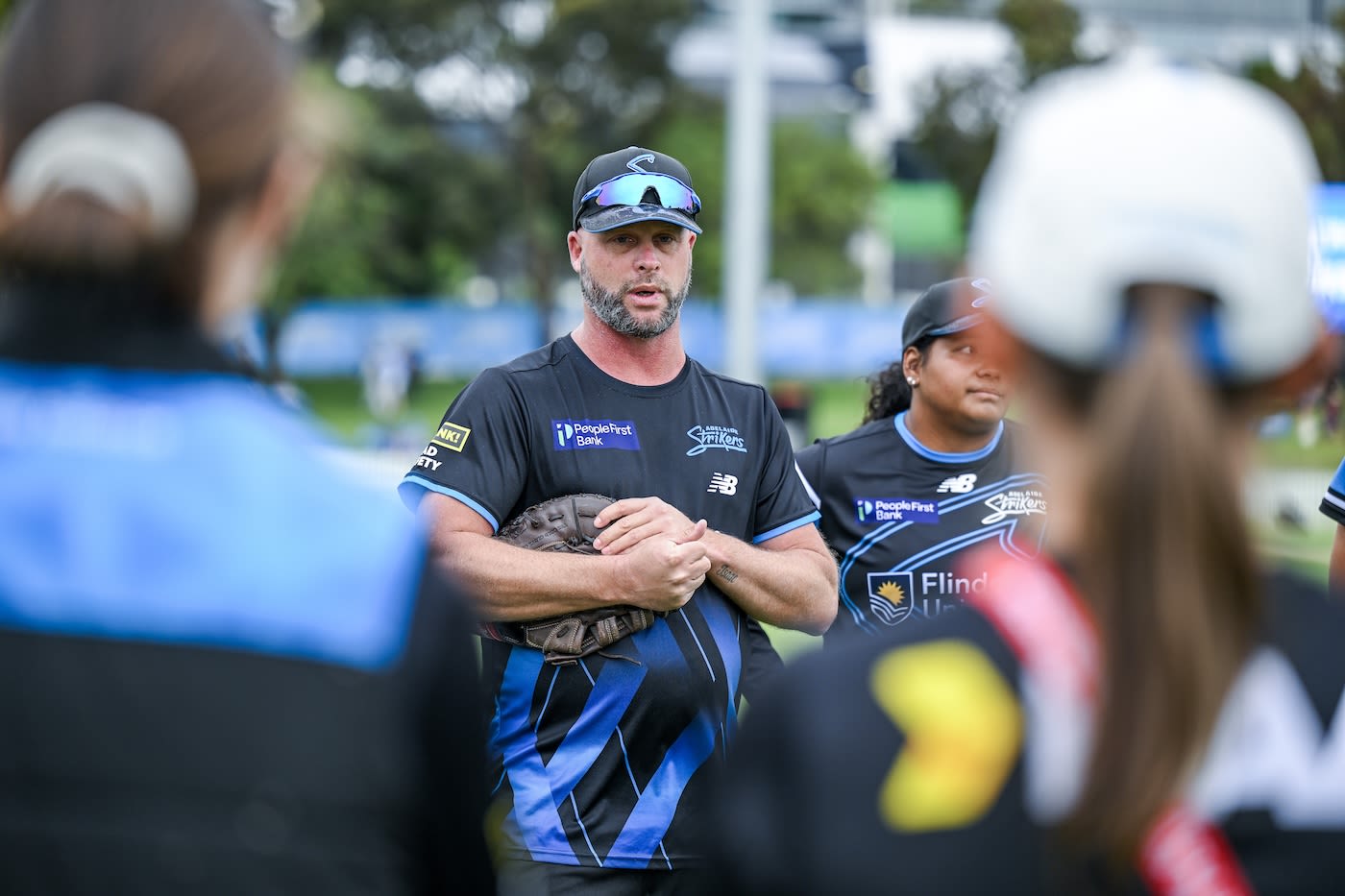 Luke Williams speaks in the huddle
