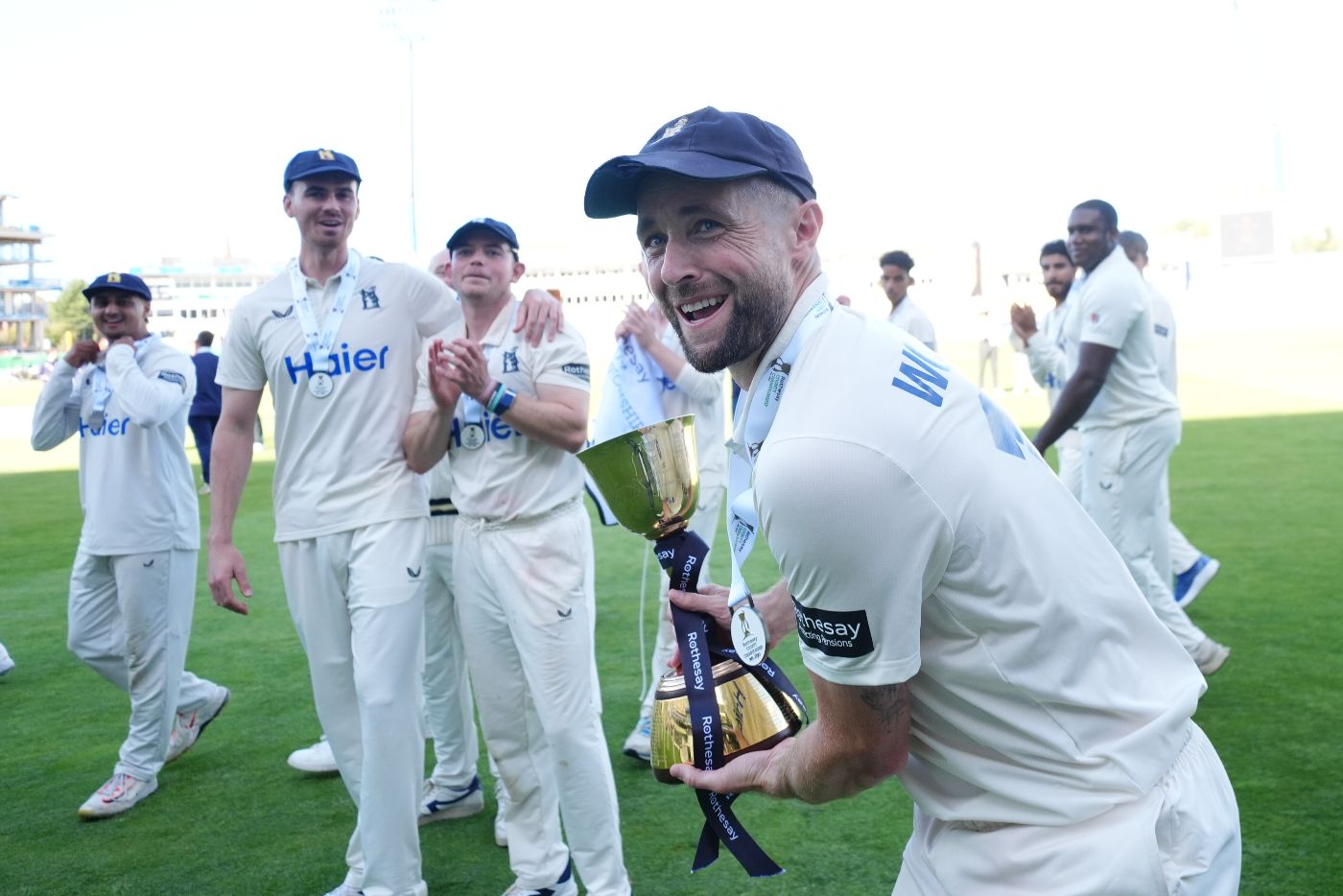 Chris Woakes parades the County Championship trophy