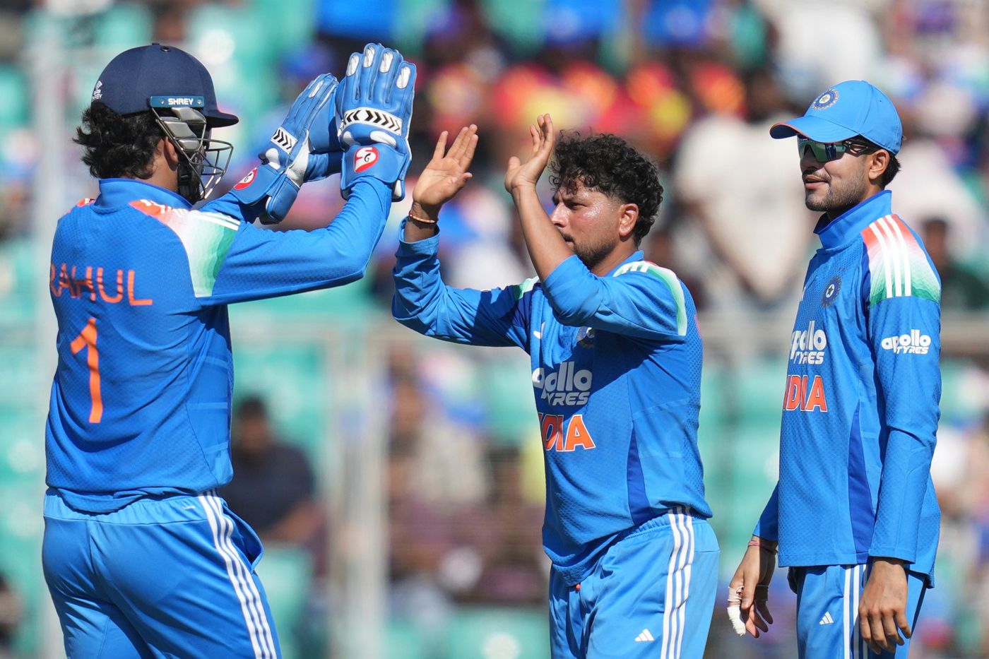 Kuldeep Yadav celebrates a wicket with KL Rahul and captain Shubman Gill