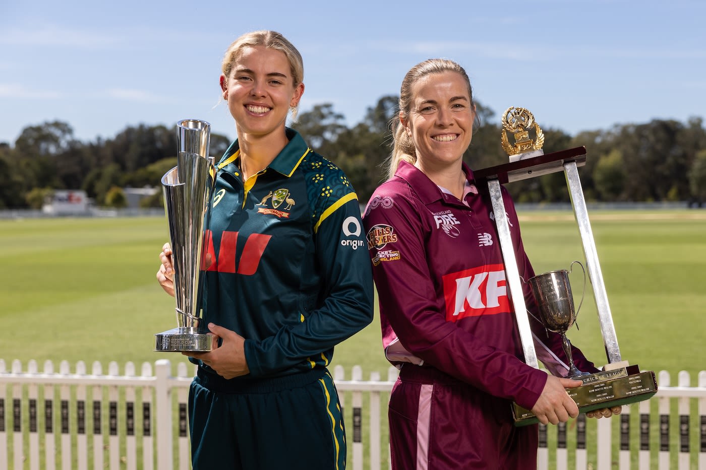 Phoebe Litchfield and Georgia Redmayne pose with the T20 World Cup and WNCL trophies