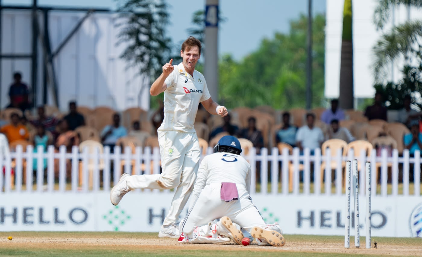 Liam Scott is all smiles after picking up a wicket
