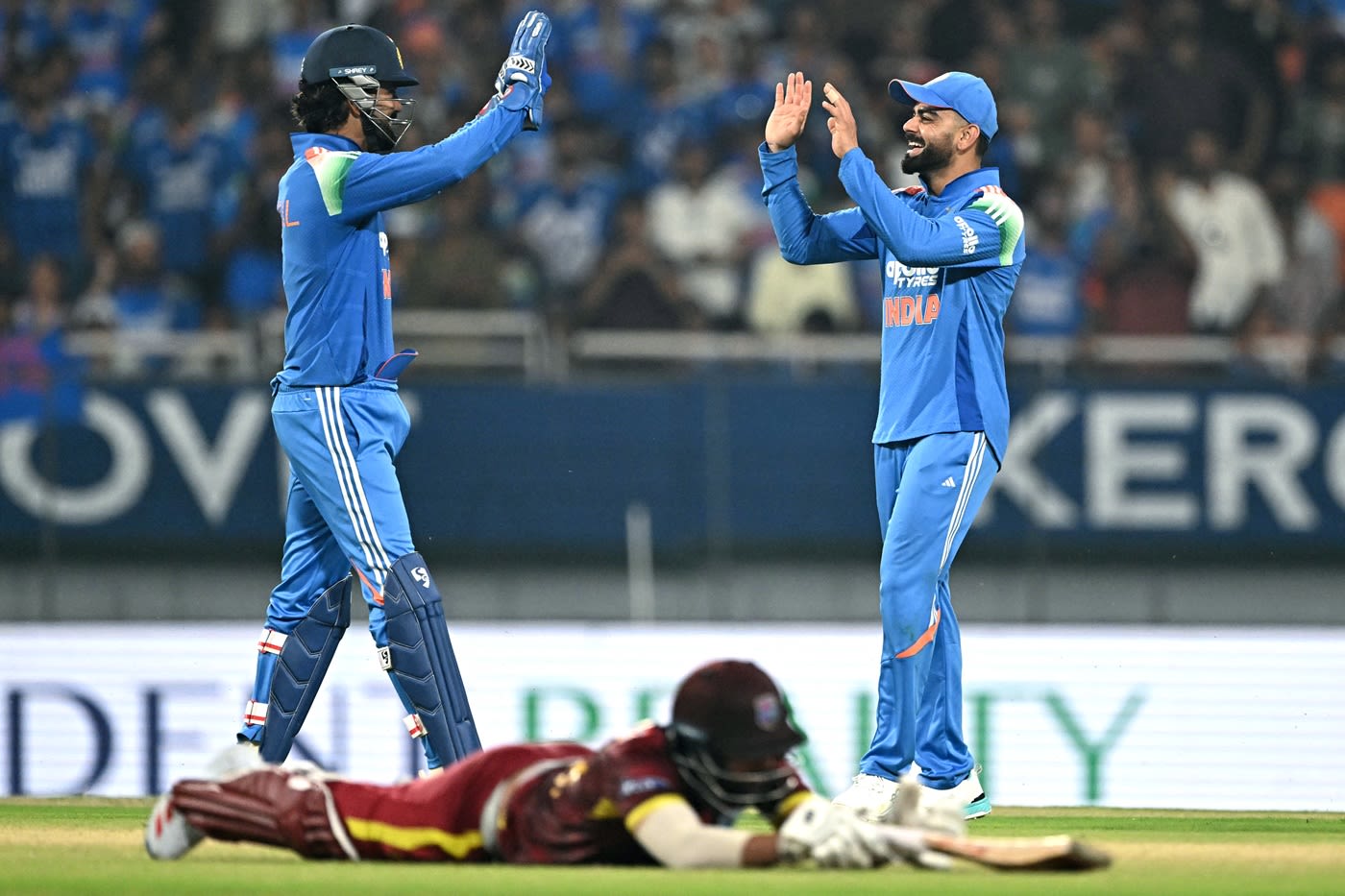 KL Rahul and Virat Kohli celebrate Amir Jangoo's run-out