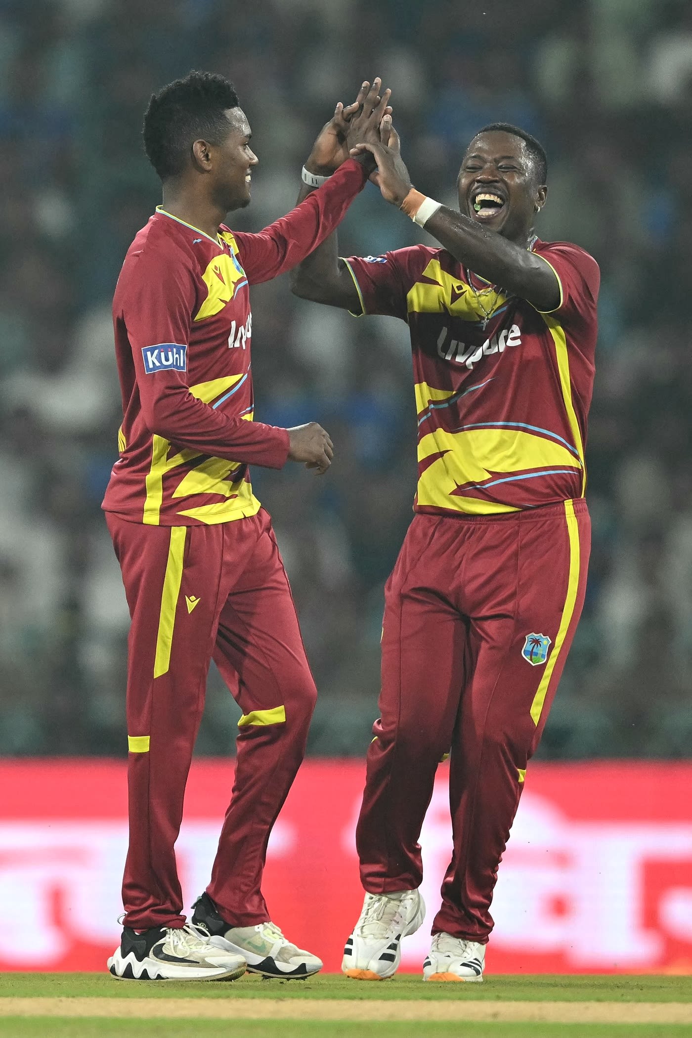 Akeal Hosein and Sherfane Rutherford celebrate Sanju Samson's wicket