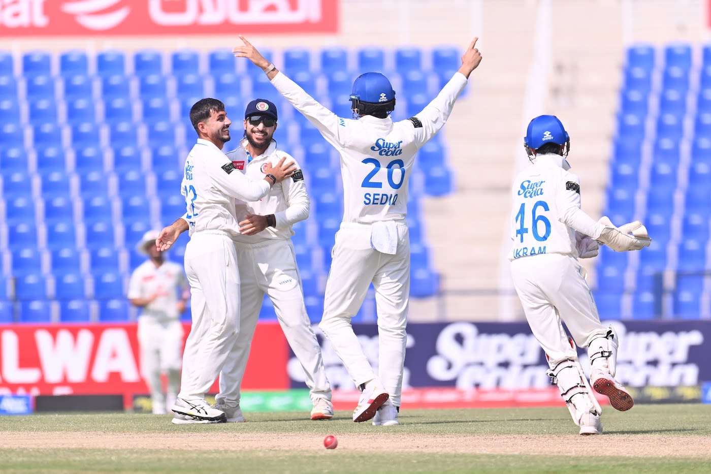 Zia-ur-Rehman celebrates a wicket with his team-mates