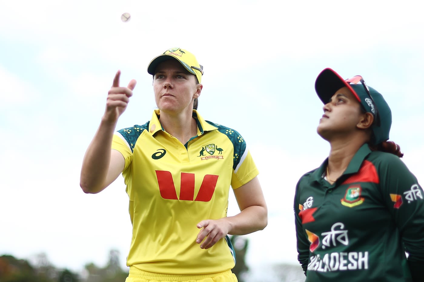 Tahlia McGrath flips the coin as Nigar Sultana looks on