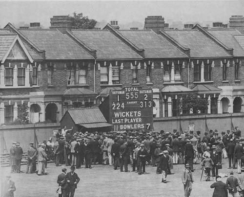 Crowds surround the scorebox after Percy Holmes and Herbert Sutcliffe's  555 first-wicket stand