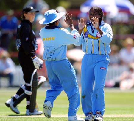 Renu Margrate runs up to congratulate bowler Neetu David after Rebecca Rolls was caught by Deepa Kulkarni