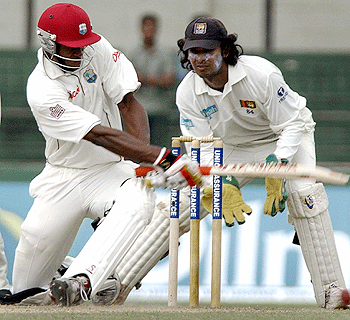 Omari Banks sweeps a ball past Kumar Sangakkara