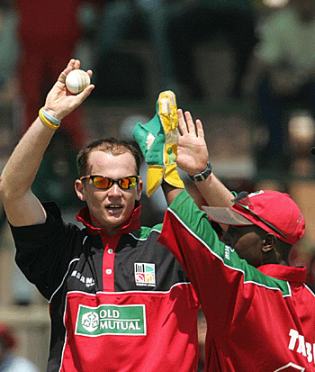 Gavin Ewing and Tatenda Taibu celebrate the fall of Brendon McCullum