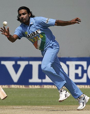 Jai P Yadav leaps across to field off his own bowling