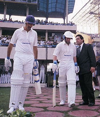 Jimmy Cook and Andrew Hudson walk out to open the innings