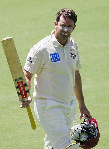 Martin Love raises his bat on completion of a hundred