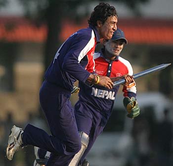Paras Khadka and Mahesh Chhetri sprint from the field complete with souvenir stump