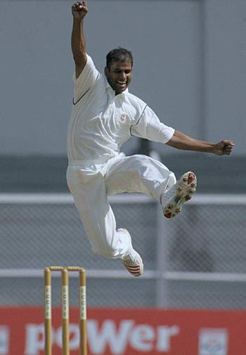 Munis Ansari celebrates taking the wicket of Andrew Flintoff