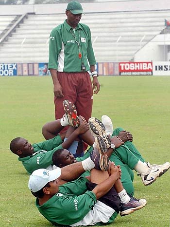 Roger Harper watches as Kenya's players loosen up