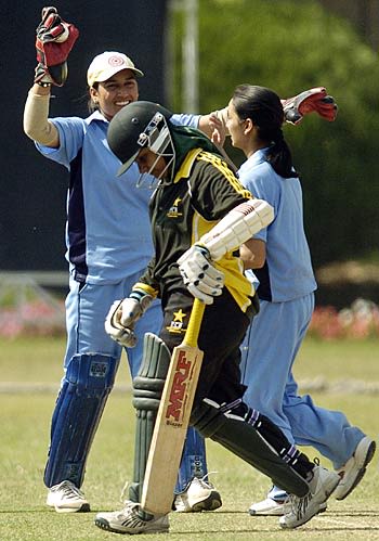 Delhi Blues Bod's wicketkeeper Gurdeep Kaur celebrates with her team-mates after the dismissal of PCB Greens' Sana Javed