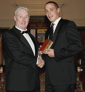 Simon Jones is presented with the Wisden Cricketer of the Year award by his father, Jeff Jones during the Wisden 2006 launch