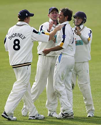 James Bruce is congratulated on the wicket of Mushtaq Ahmed