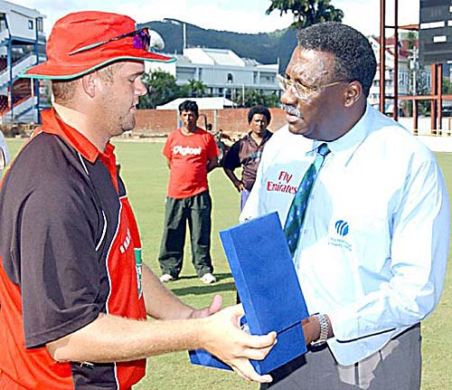Piet Rinke collects his Man-of-the-Match award from Clive Lloyd