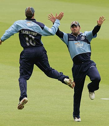 James Benning of Surrey celebrates catching Ed Smith