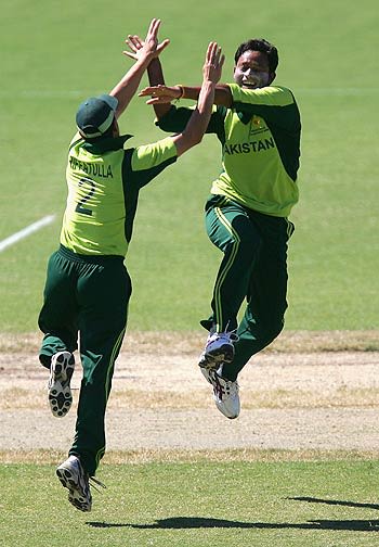 Rafatullah Mohmand and Wasim Khan celebrate the fall of Michael Papps