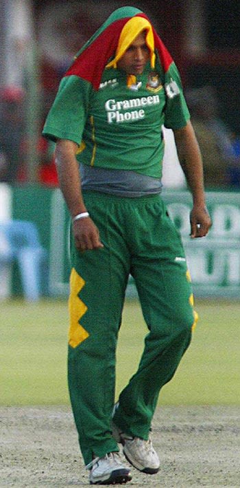 A dejected Mashrafe Mortaza trudges away after being hit for six off the last ball