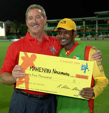 In the money... Mahendra Nagamootoo accepts the Man of the Match award cheque from Allen Stanford