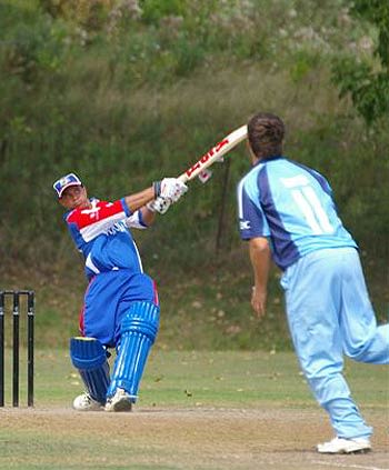 Lionel Cann slams one of his five sixes during his undefeated 139