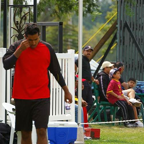 Kevin Sandher, the Canadian slow left-arm bowler, deep in thought after taking three wickets for 24 against USA