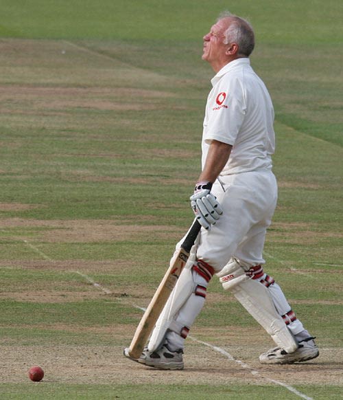 Former Middlesex and England batsman Clive Radley grimaces after missing a leg-side full toss