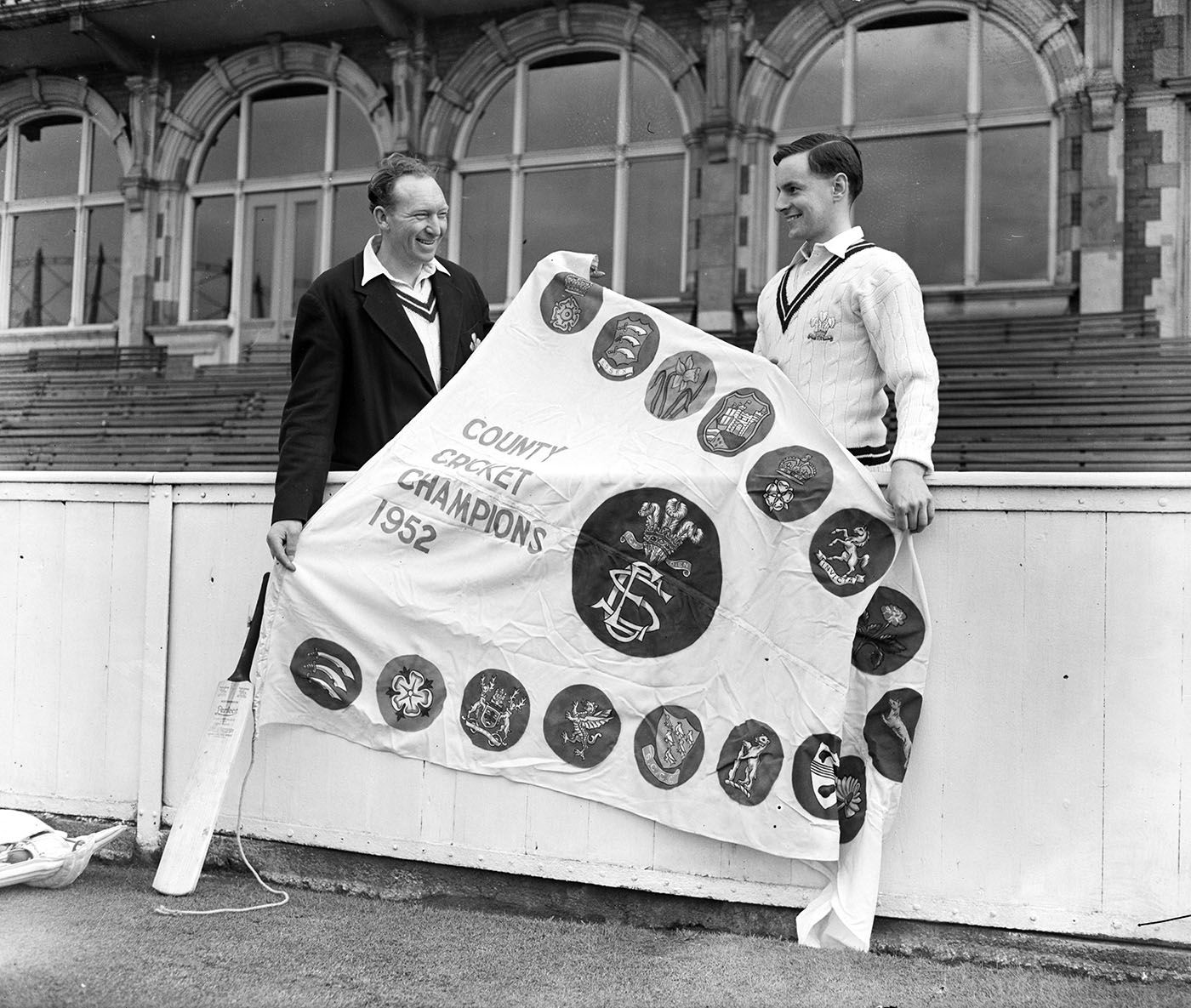 Stuart Surridge and Peter May pose with the 1952 Championship pennant