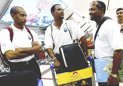 Ian Bradshaw, Runako Morton and Brian Lara wait for their luggage at Chattrapati Shivaji Airport in Mumbai