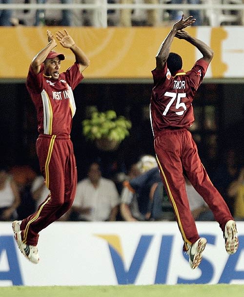 Jerome Taylor and Ian Bradshaw celebrate Ricky Ponting's wicket