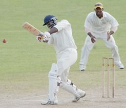Alcindo Holder smashing a straight hit off Ryan Nurse