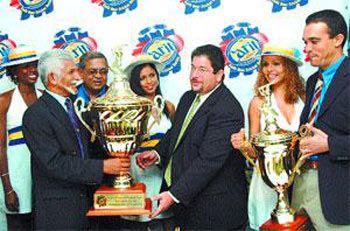 Deryck Murray receives the Carib International Challenge Trophy from Carib CEO Andrew Sabga
