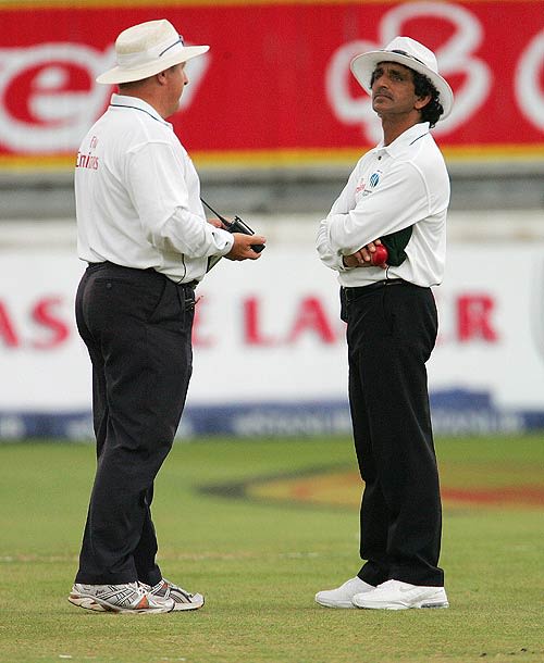 Umpires Ian Howell and Asad Rauf in discussion about the fading light at Kingsmead