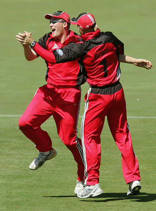 Nathan Adcock and Matthew Elliott celebrate the dismissal of Adam Voges