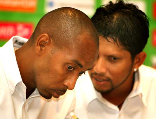 Ian Bradshaw listens to Ramnaresh Sarwan during a press conference, in Montego Bay
