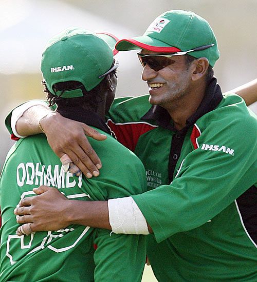 Ravi Shah congratulates Nehemiah Odhiambo on taking a catch
