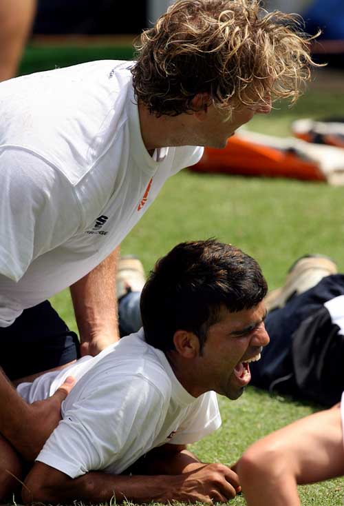 Daan van Bunge of the Netherlands shares light moment with team-mate Mohammad Kashif at Warner Park